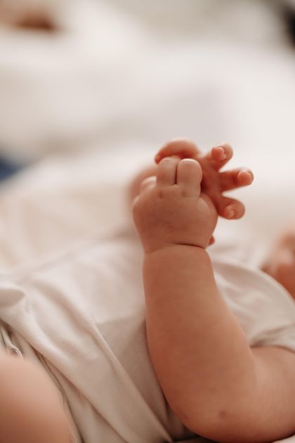 Mani di un infante che si manipolano tra loro